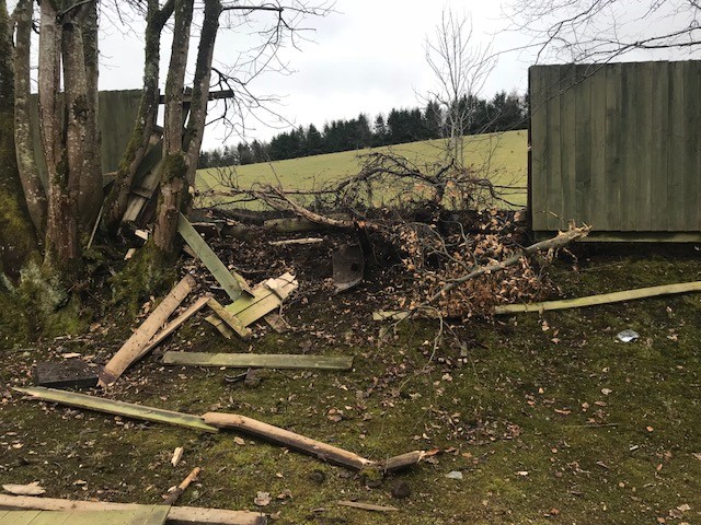 Vehicles plough through the wooden structure after coming round a nearby bend