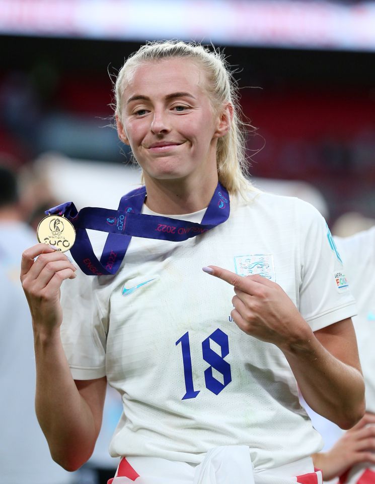 Manchester City striker Kelly poses with her winner's medal following the full-time whistle