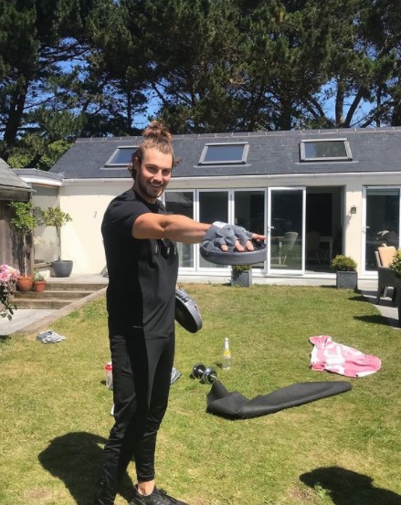 Andrew shared a snap of himself working out in a huge garden