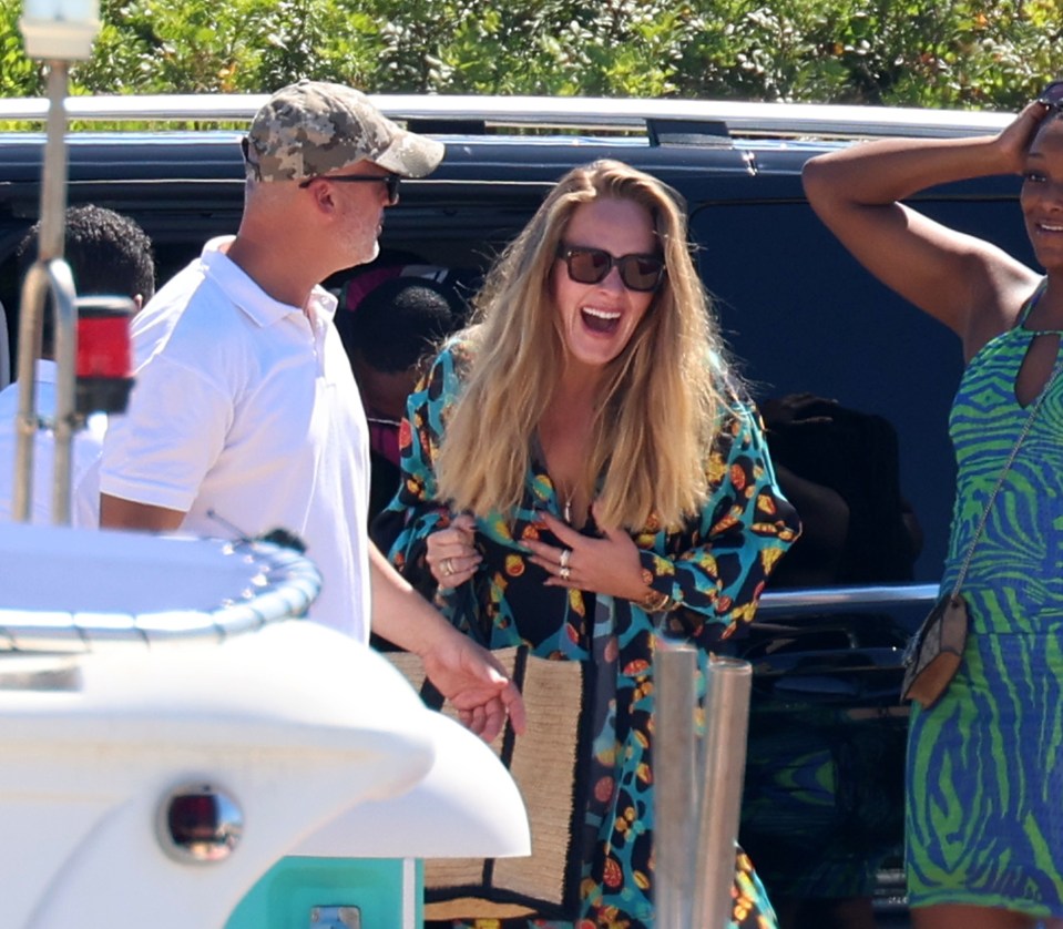 Adele has a laugh before boarding a boat