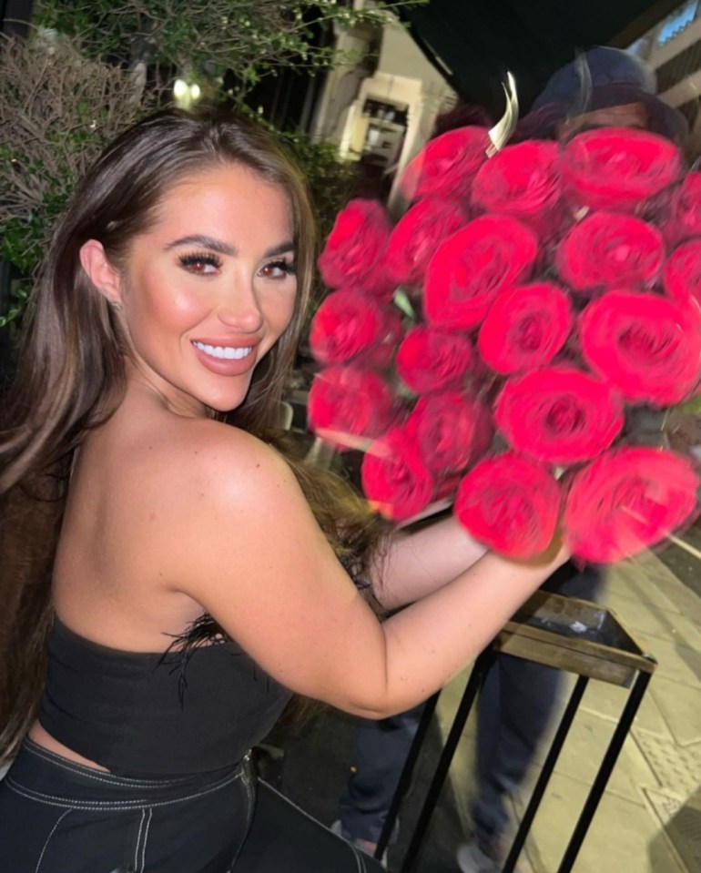 Chloe flashed a big smile while holding a huge bouquet of roses