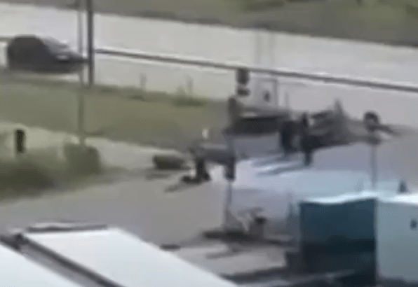 The gunman is filmed getting to his knees after the swoop by cops