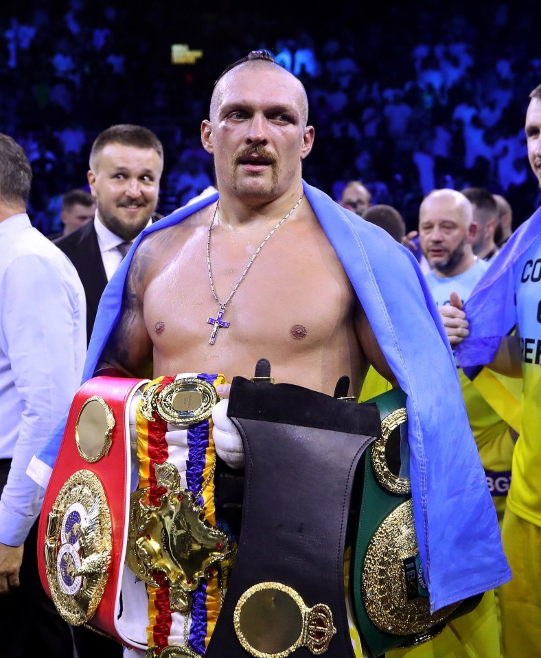 Oleksandr Usyk poses with his world titles after beating Anthony Joshua