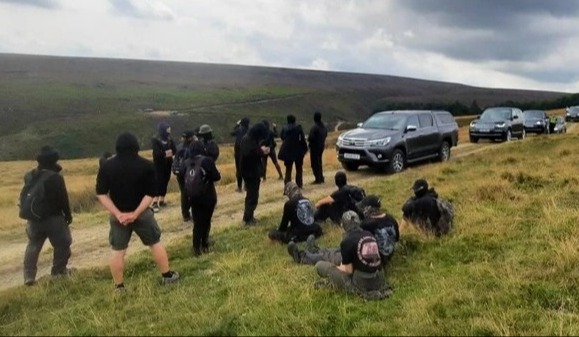 Masked protesters block the hunt party’s car