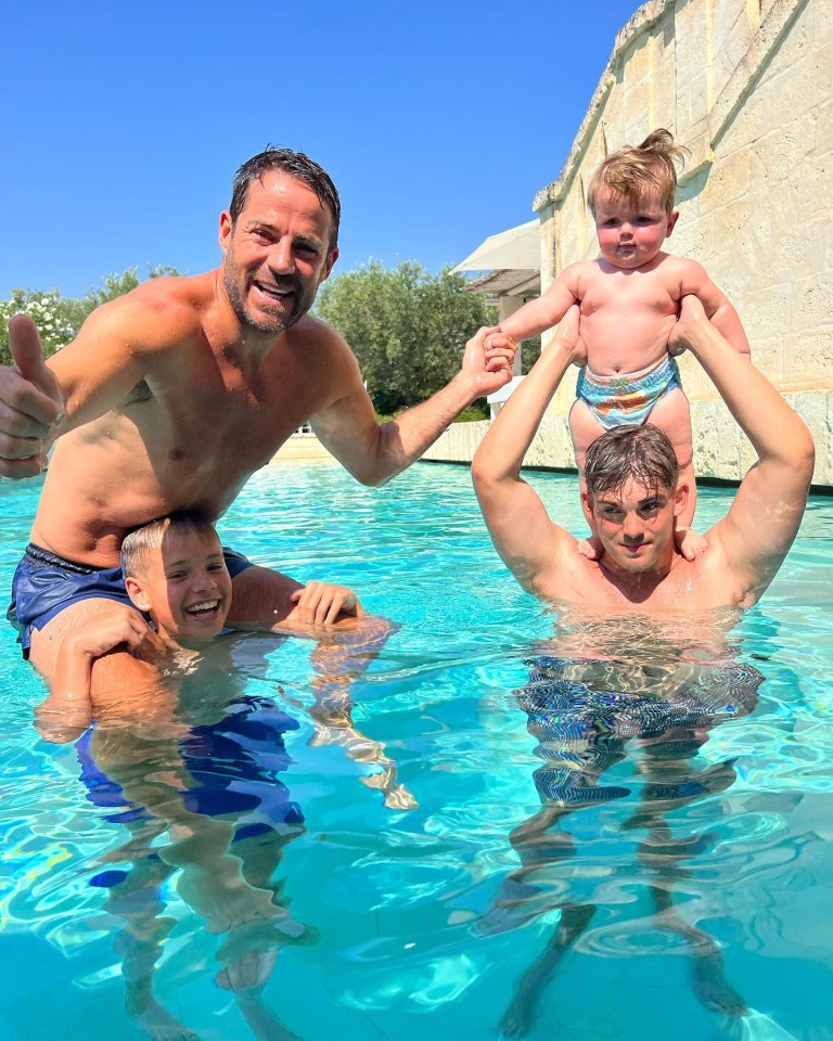 Jamie beamed as he balanced on the shoulders of his son Beau, 13, while Charley, 18, held baby Raphael