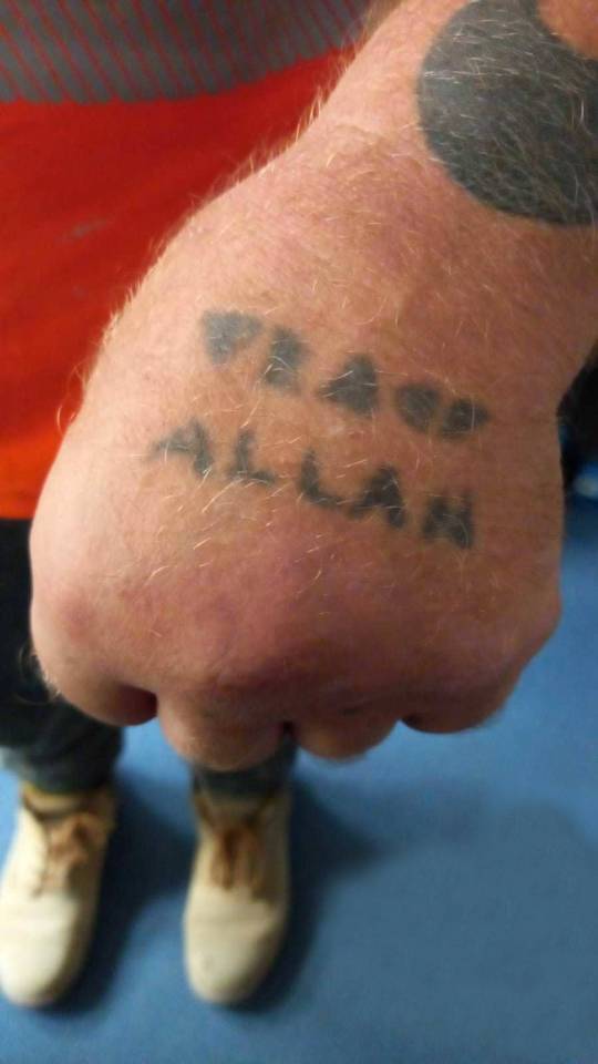 A tattoo on the back of the grandad's hand is a second etching of his misspelt first name