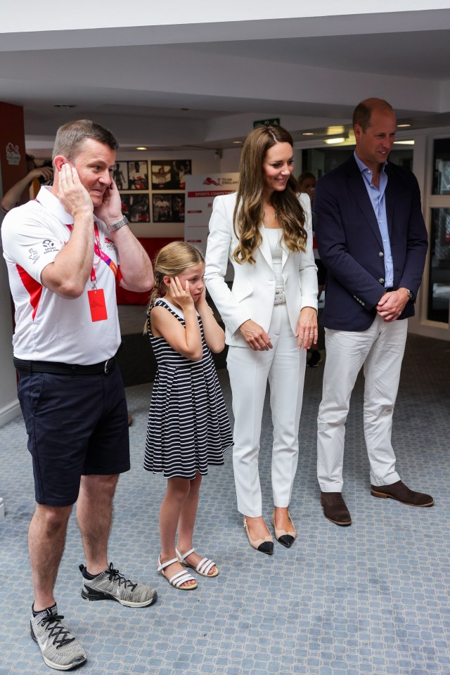 Tim Lawler CEO of SportsAid and the royals watch a demonstration of a bicycle powered smoothie maker during a visit to SportsAid House