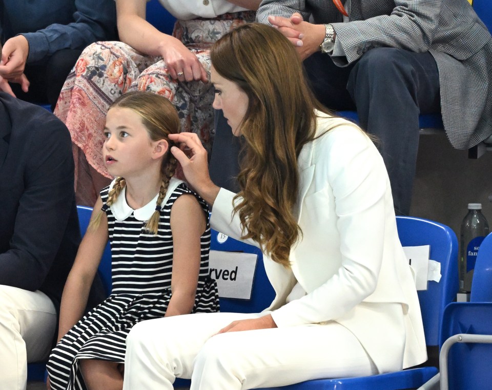 Kate protectively tucked her daughter's hair behind her ear