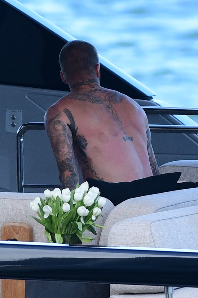 David's tattoos were on show as he reclined and overlooked Miami