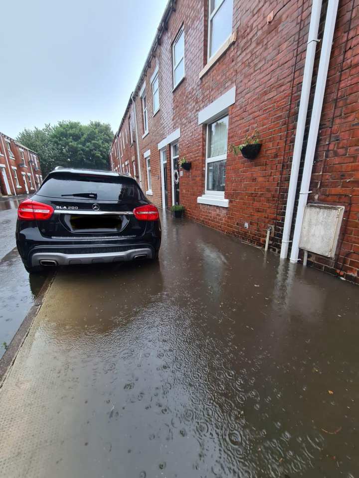 The road filling with water during rainfall on July 25