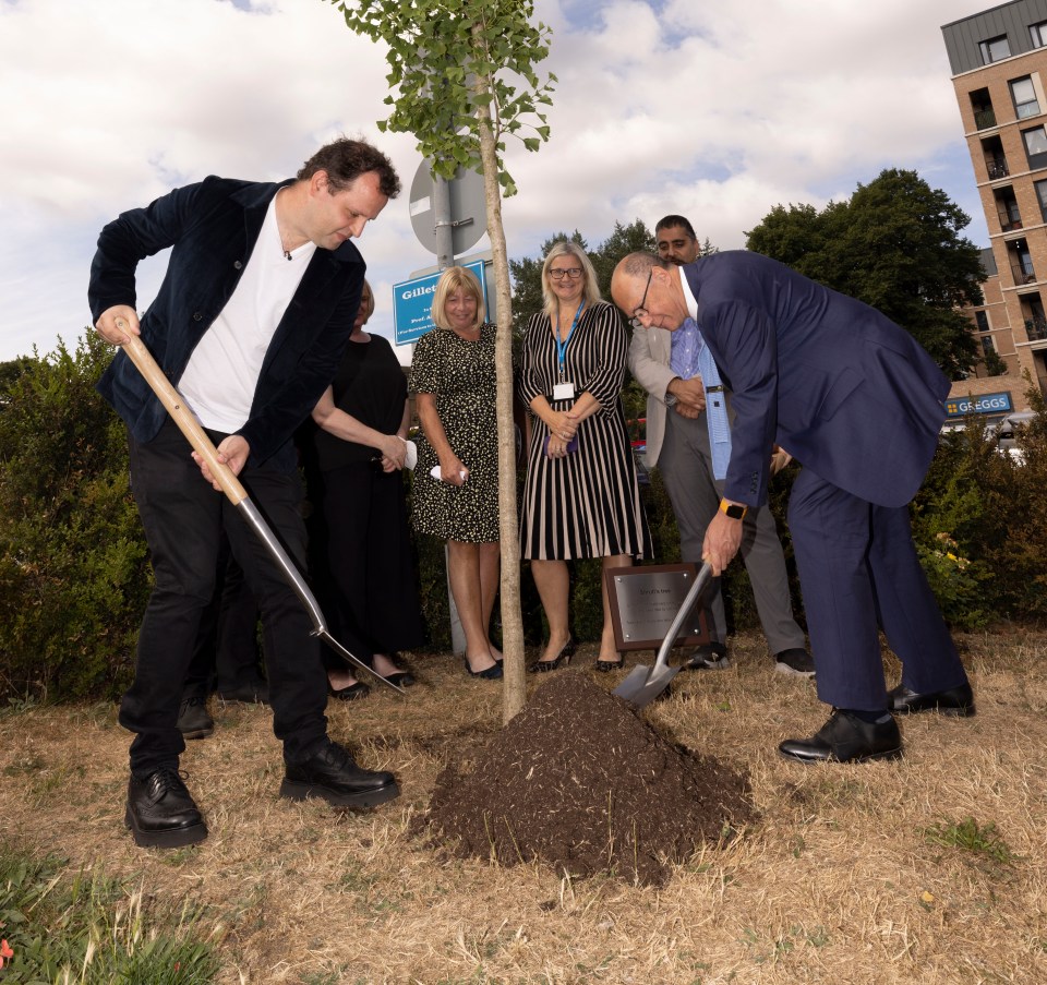 Adam planted the tree alongside the NHS's medical director, Stephen Powis