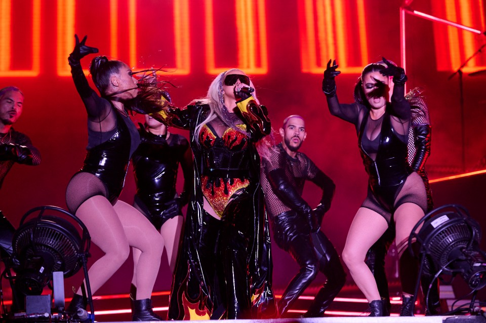 Christina wore this black PVC outfit with sequinned flames for her set