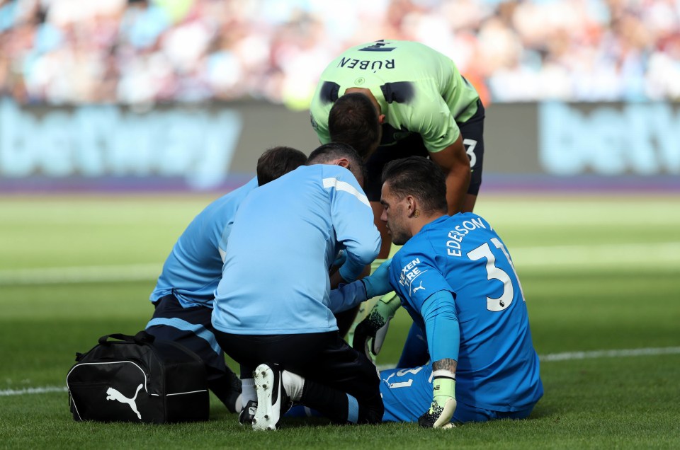 Medical staff and an apologetic Ruben Dias tended to Ederson after he came off worse for wear during the corner