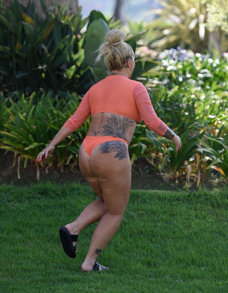 She was seen in an orange thong bikini