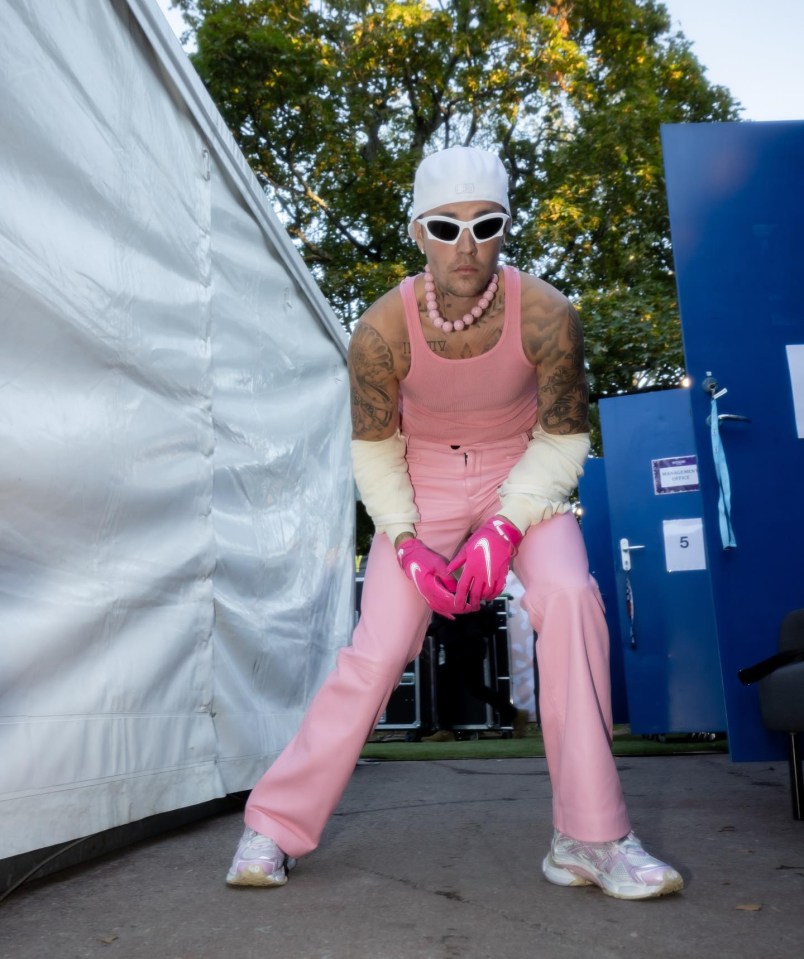 Justin Bieber teamed a pink vest with matching PVC trousers and bright Nike wool gloves on stage in Finland