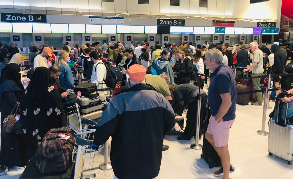 Holiday makers queue at Manchester Airport early today