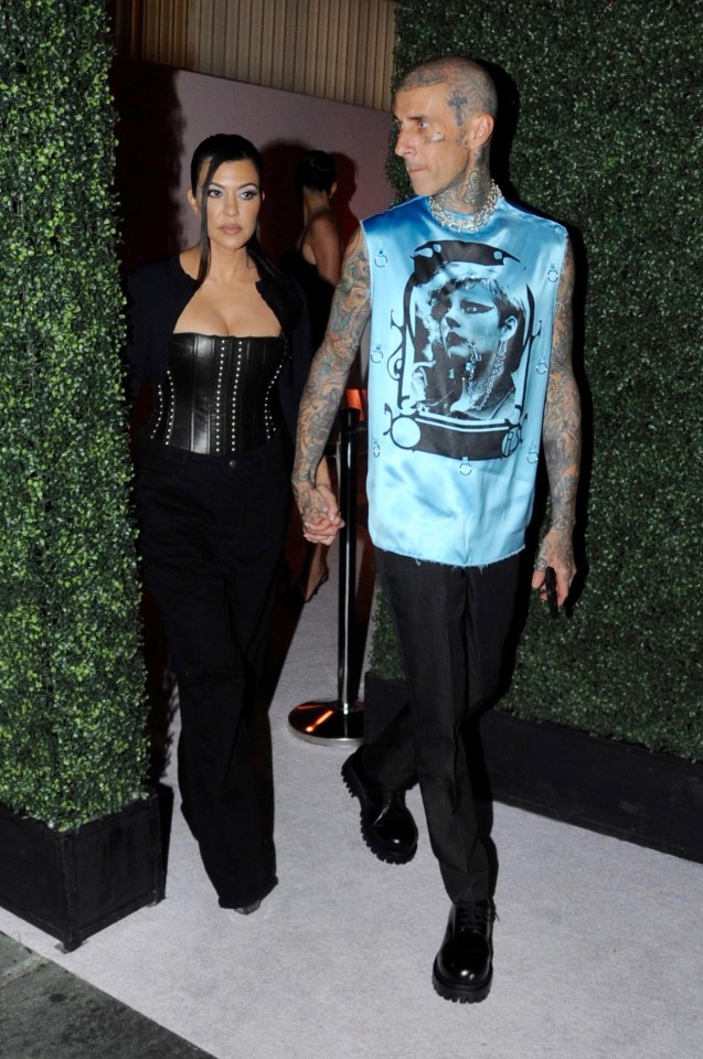 Kourtney, 43, wore a leather corset as she held hands with Travis Barker