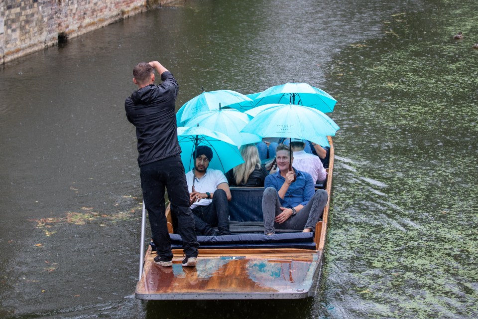 The umbrellas were out during a punt on the River Cam in Cambridge today