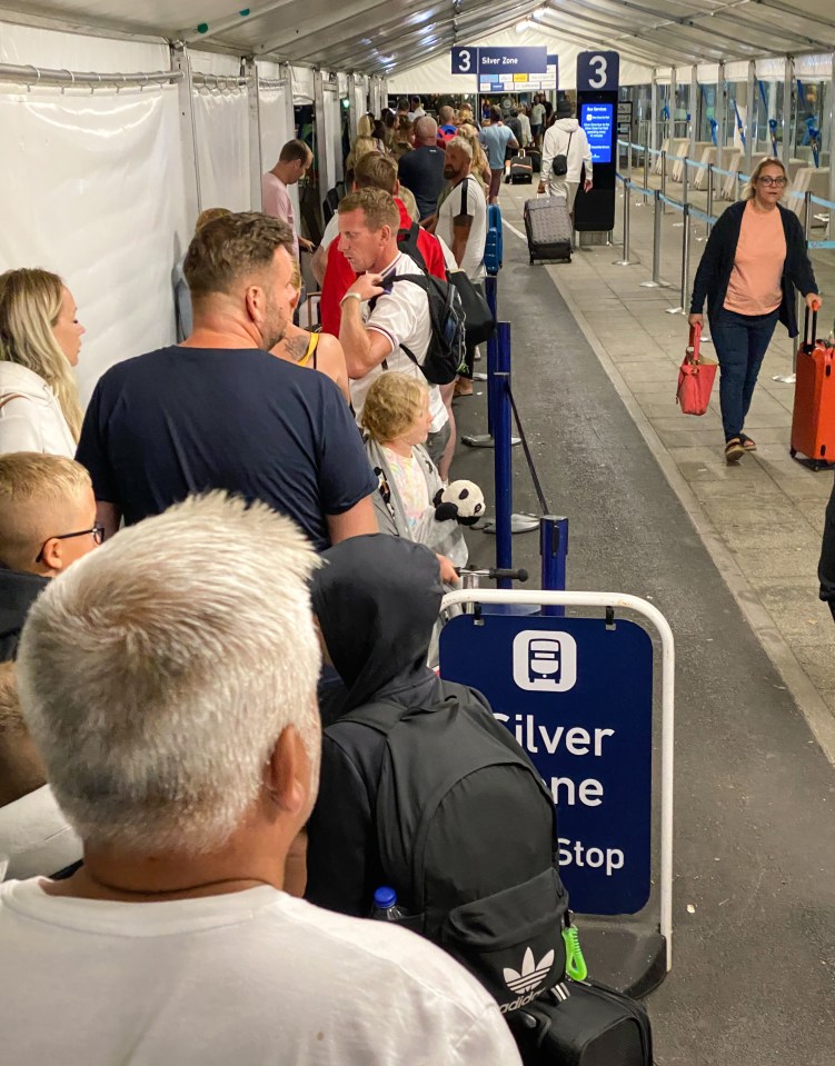 Travellers queue out of the airport in Bristol as the Bank Holiday rush begins