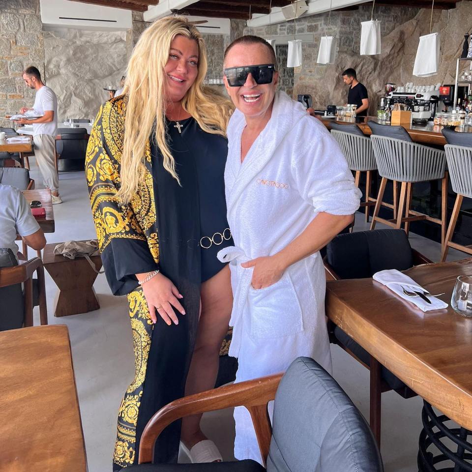 She posed with Julien MacDonald at a beach bar