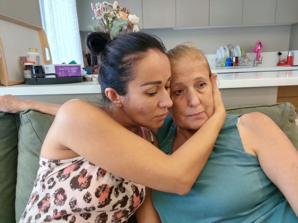 Lidia being comforted by her daughter