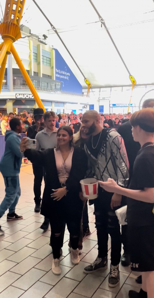 The boxer looked relaxed as he posed for photos with fans