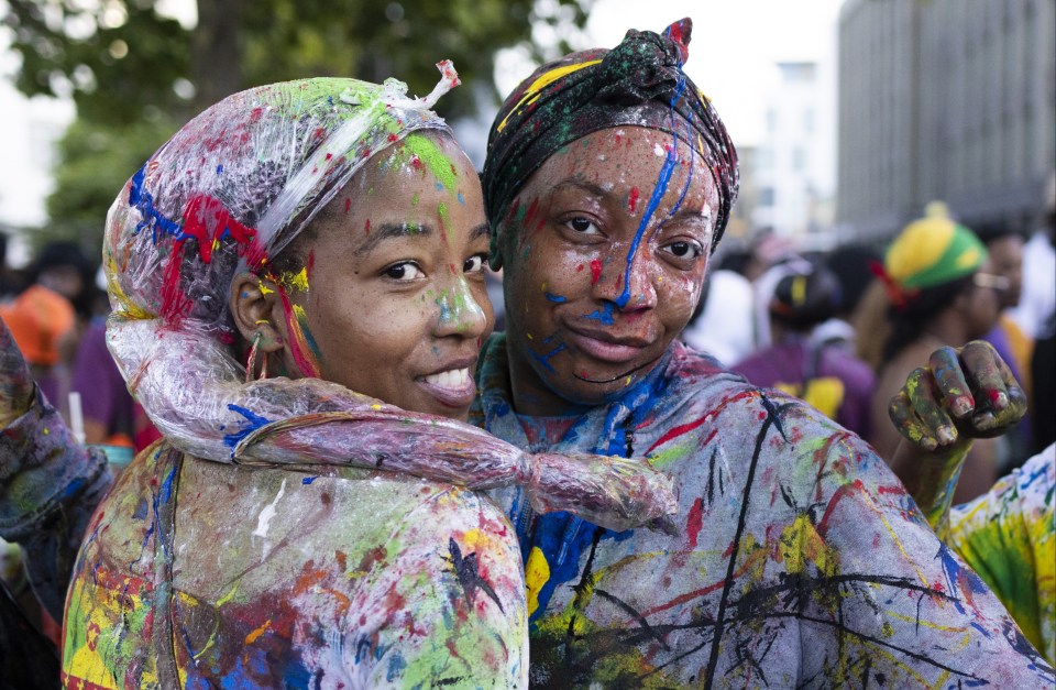 Revellers covered in paint at the opening of the Notting Hill Carnival