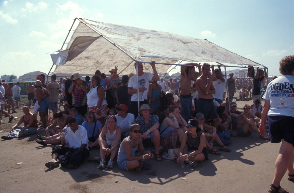 The fans huddle under a rare shade structure