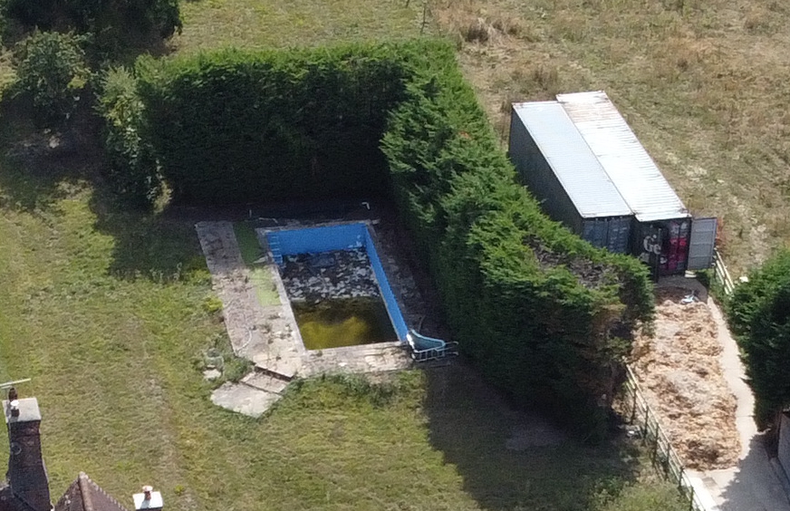 The pool is now green and filled with rubble