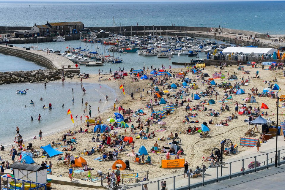 Beachgoers in Dorset sunned themselves as Britain's toasty summer continued