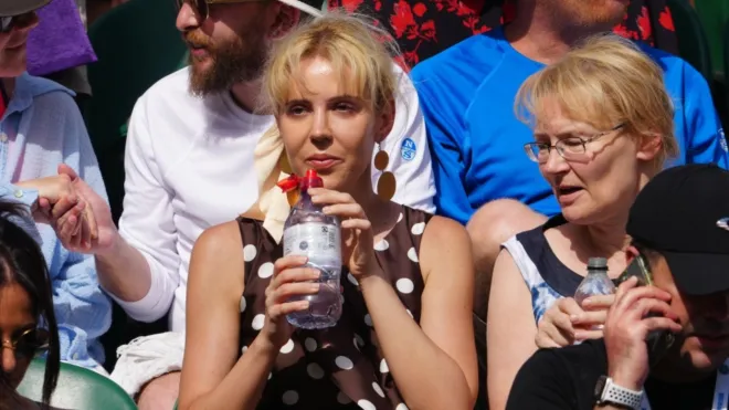 Ania Palus (centre) was the women in the dress Nick Kyrgios objected to