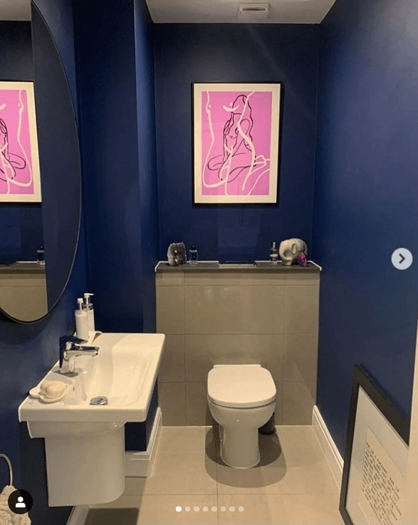 The downstairs bathroom features stunning art