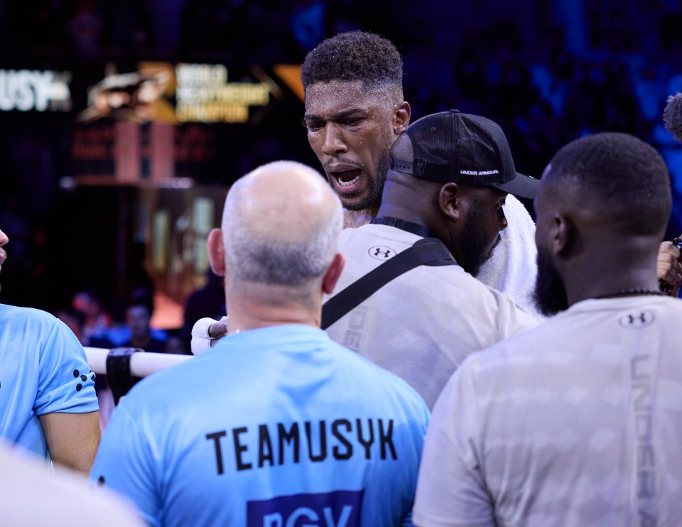 Anthony Joshua had to be held back