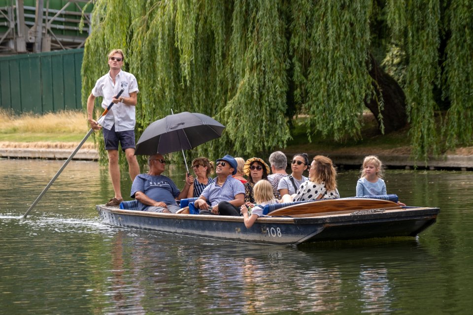 People out punting on the river Cam in Cambridge making the most of the sun before the rain this week