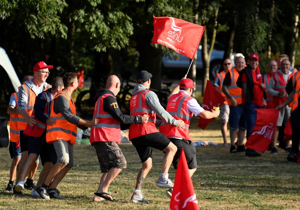 Strikers dance whilst protesting near an entrance to the UK’s biggest container port Felixstowe