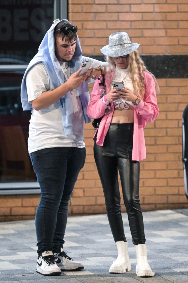 Two friends took a moment to check their phones during their night out