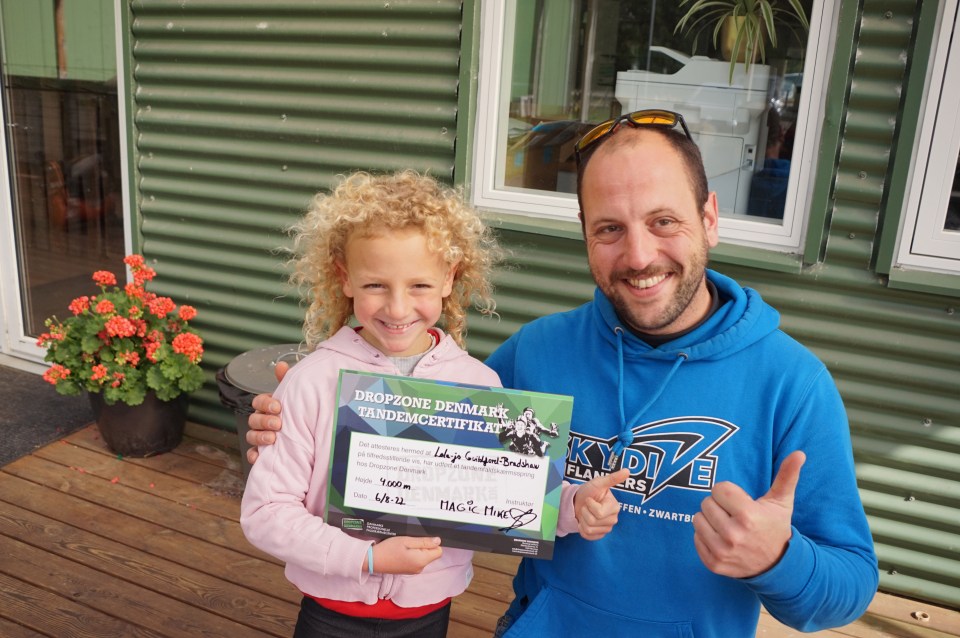 Lola-Jo proudly shows off her certificate commemorating her jump