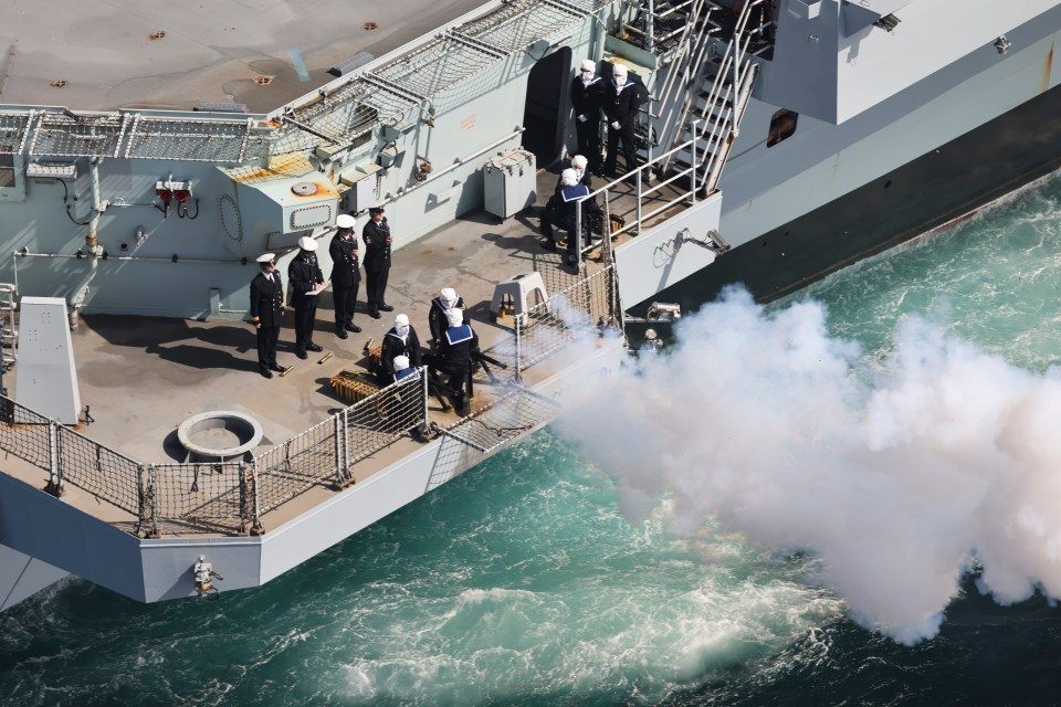 An aerial view of the 96 gun salute, taken from a Merlin Mk2 helicopter of 820 Naval Air Squadron embarked on board HMS Queen Elizabeth