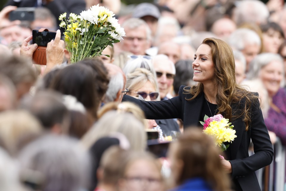 Princess Kate was seen collecting flowers from royal well-wishers