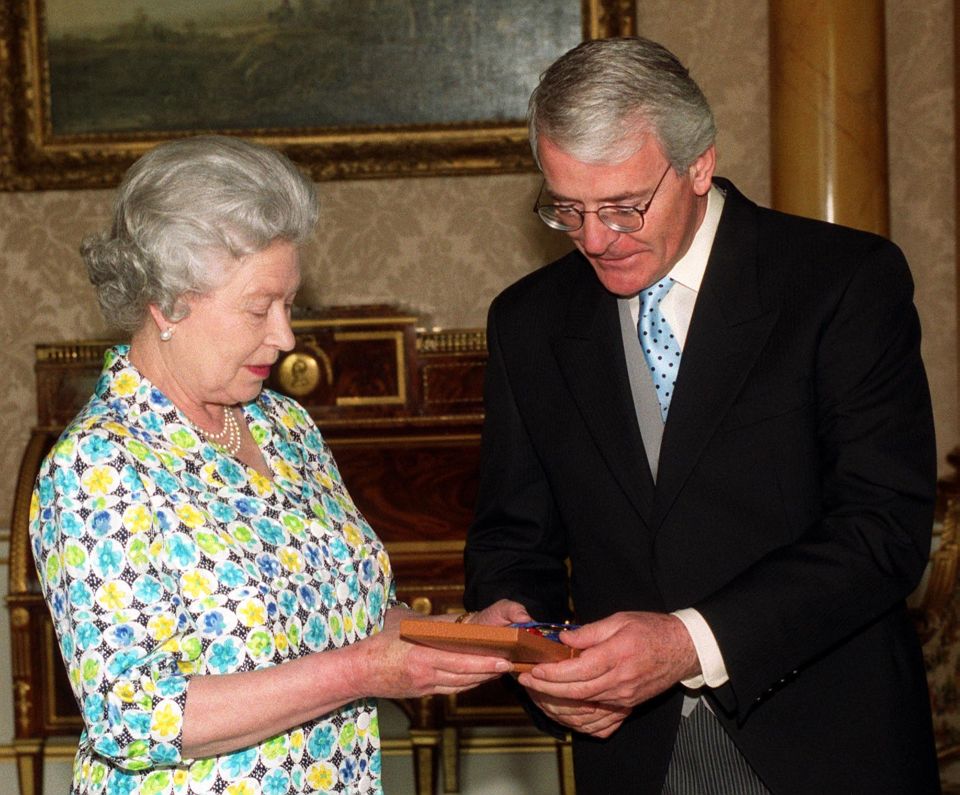 Prime Minister John Major receiving the Companion of Honour from The Queen at Buckingham Palace