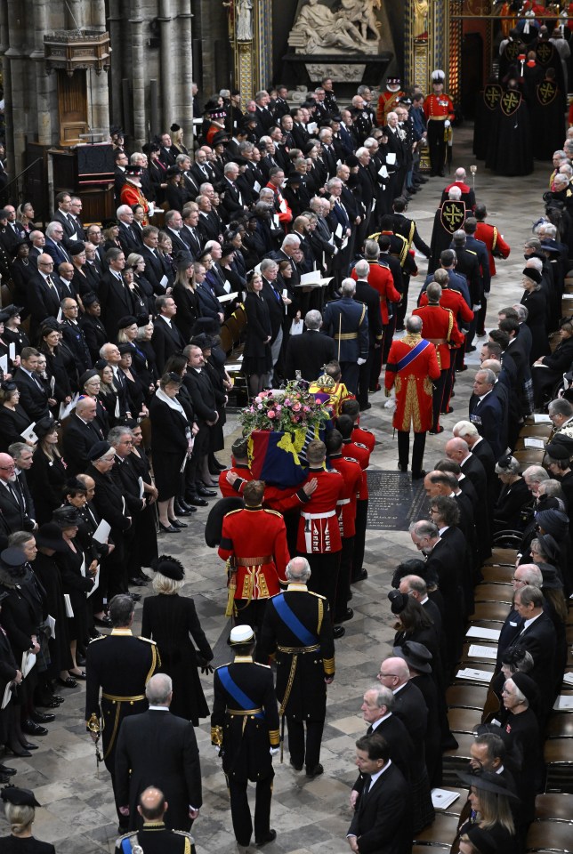 The coffin is carried by the Bearer Party into Westminster Abbey