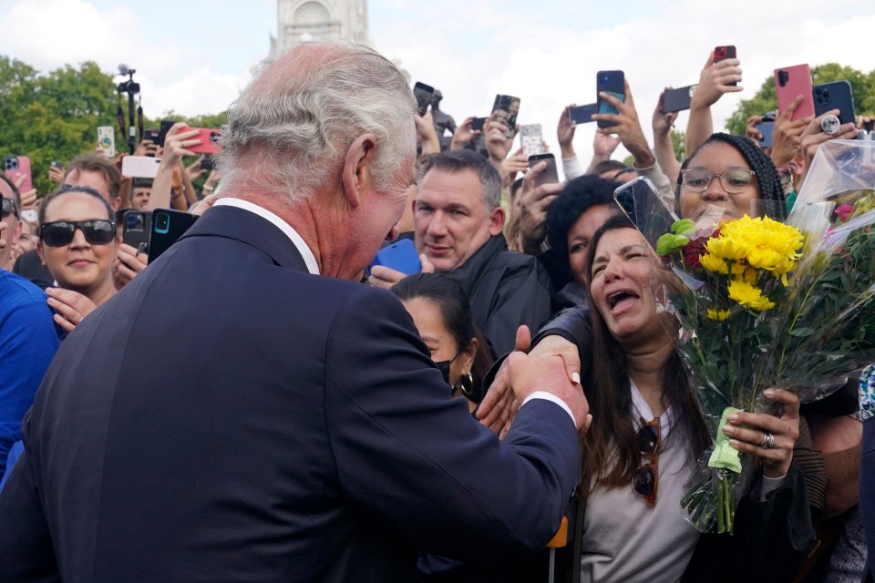 One woman was visibly emotional as the crowd leant in to shake the monarch's hand