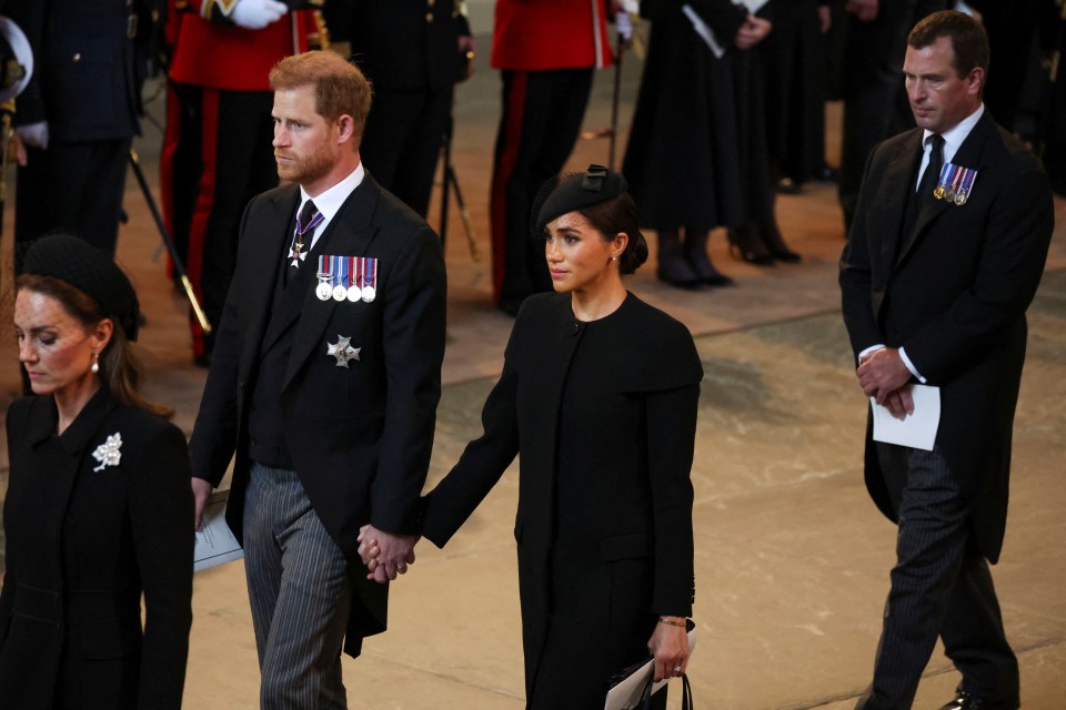 The Duke and Duchess of Sussex held hands in Westminster Hall yesterday for the Royal procession