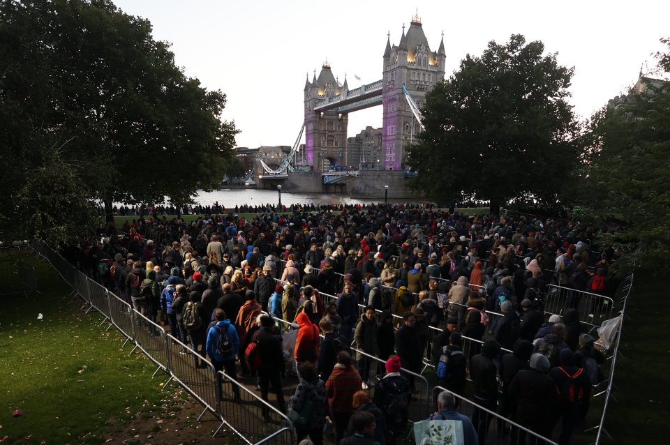 Mourners line the banks of the Thames at dawn