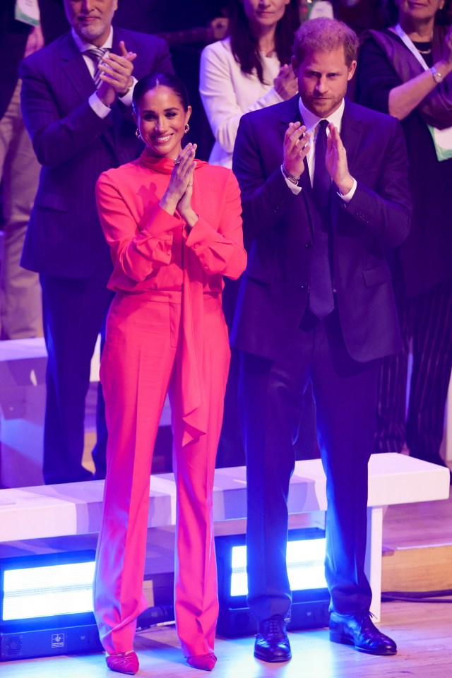 The Duke and Duchess of Sussex looked delighted as they joined One Young World counsellors on stage tonight