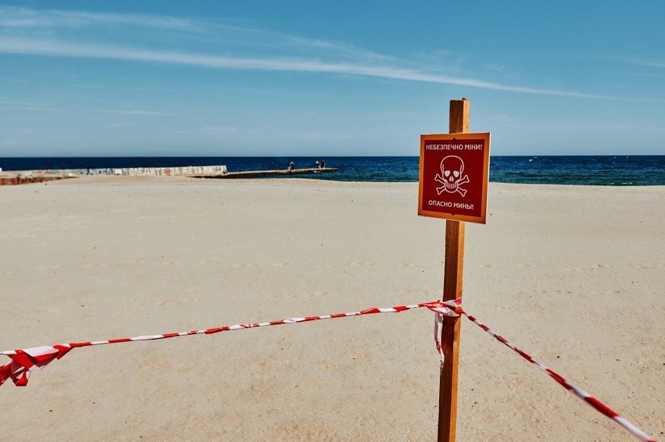 Beaches in Ukraine have signs that read 'caution: mines' on them