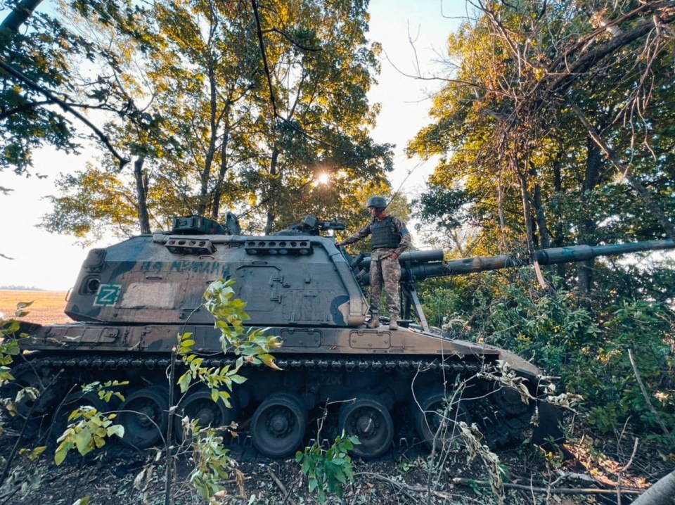 A Ukrainian solider inspecting an artillery gun