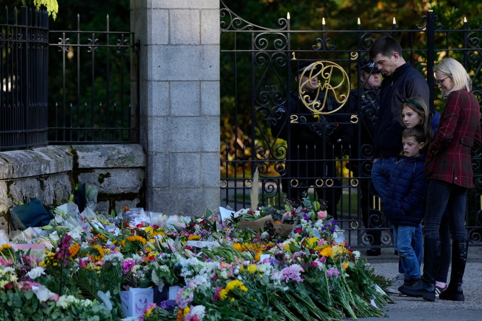 Crowds gathered outside Buckingham Palace to lay flowers following the Queen's death