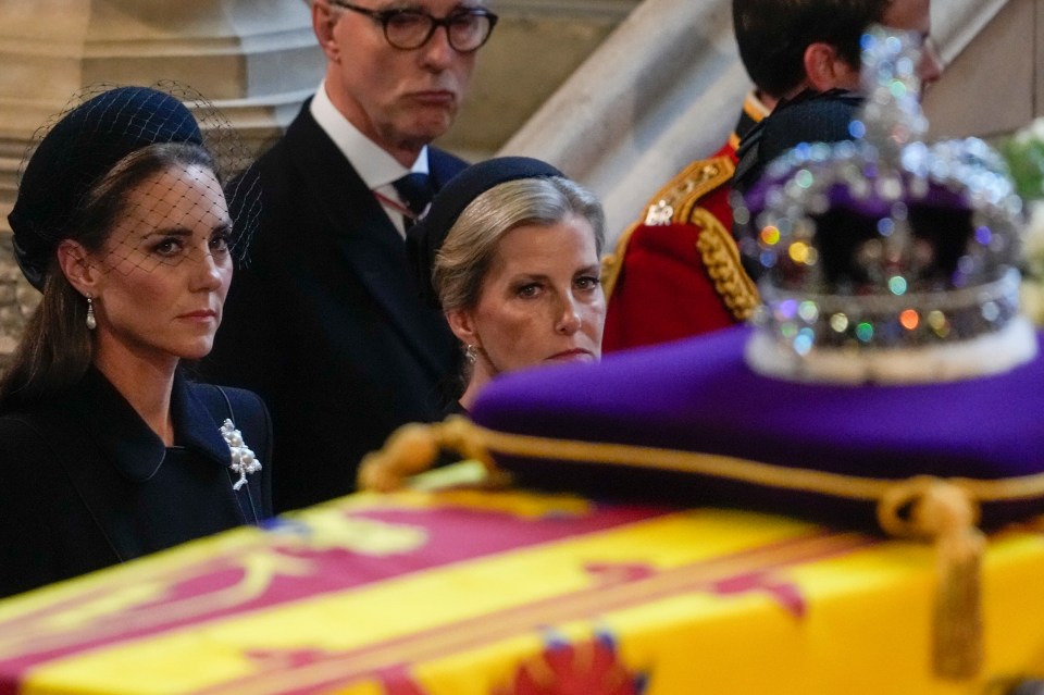 Kate, Princess of Wales and Sophie, Countess of Wessex, stare up at The Queen's coffin and the Imperial Crown inside Westminster Hall