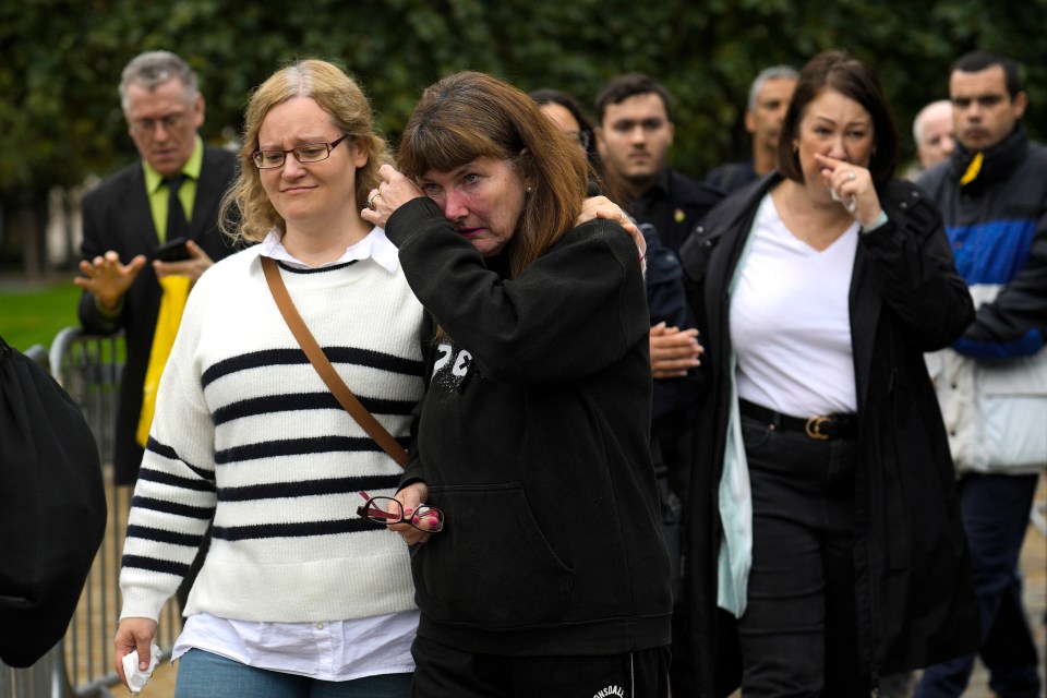 One woman weeps as she leaves Westminster Hall today